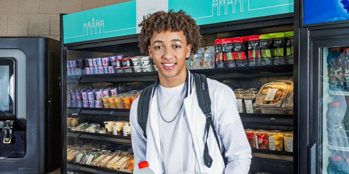 Student smiling in c-store
