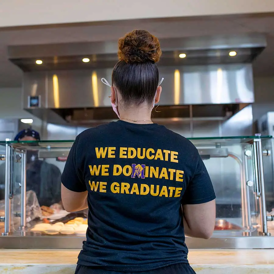 Student waiting in cafeteria serving line