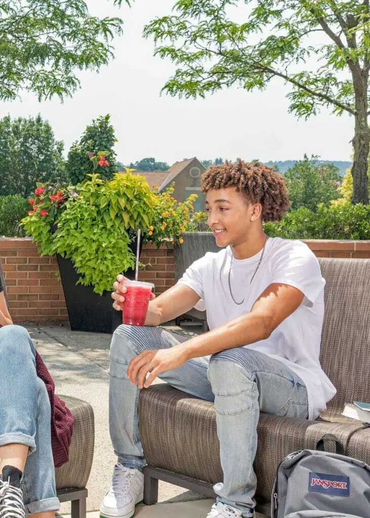 Student having a beverage and conversation